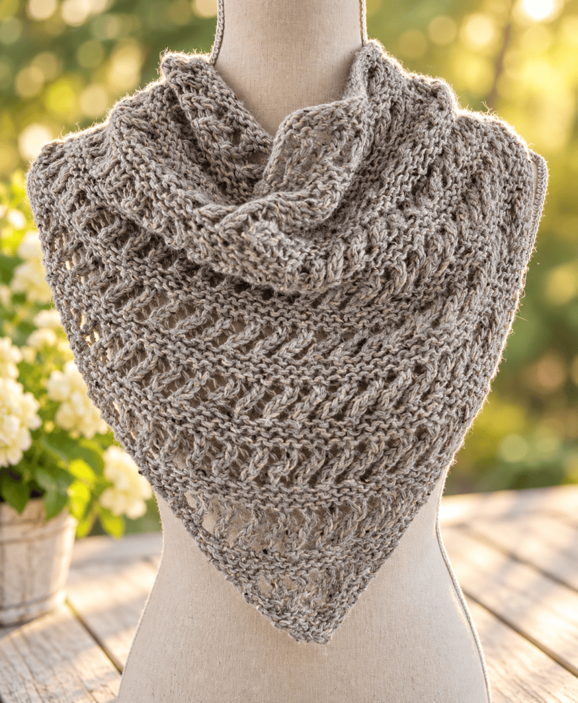 grey knitted lace triangle draped on a manequin